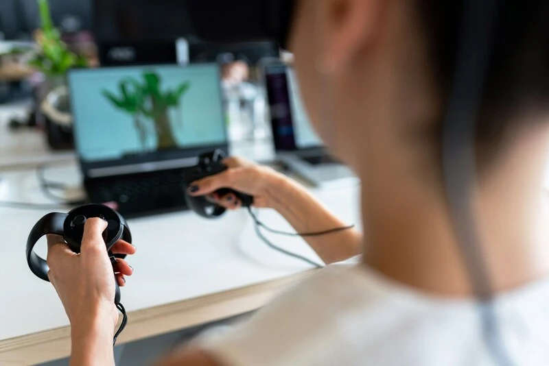 A Close-up of a player using dual hand controllers, representing AI-powered gameplay and immersive character interaction.