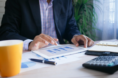 Expert analyzing chart on a tablet for financial translation service.