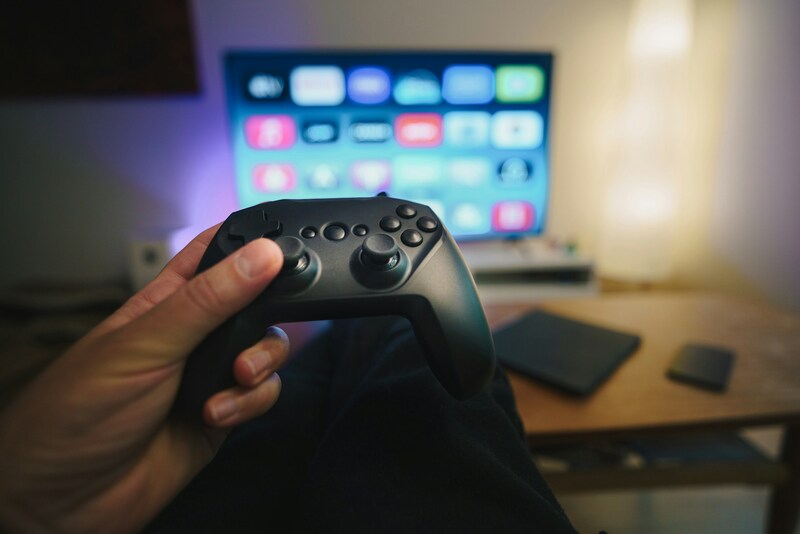 A modern gaming environment with a controller and TV setup reflecting the connected future of the game industry.