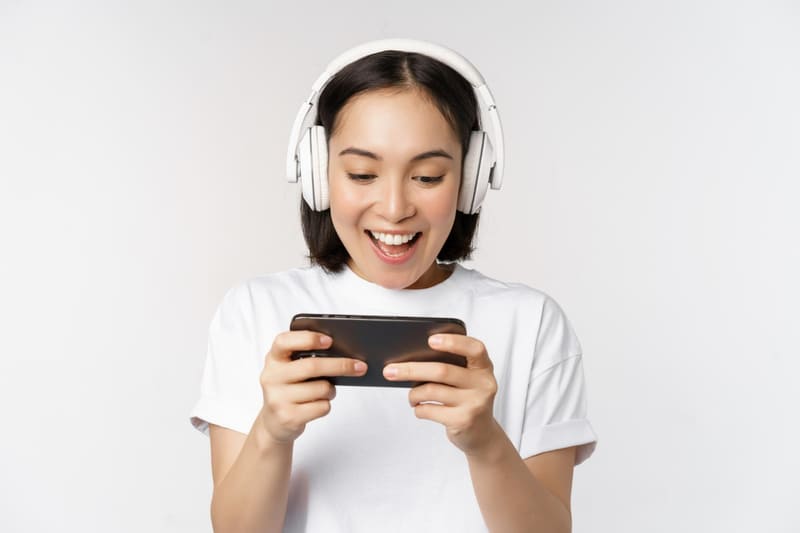 A female gamer playing a game with an immersive sound effect that releases dopamine during the win moment.