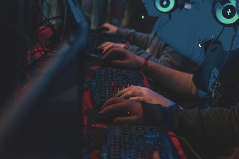 Software developer team performing quality assurance on a game project at their workstation.