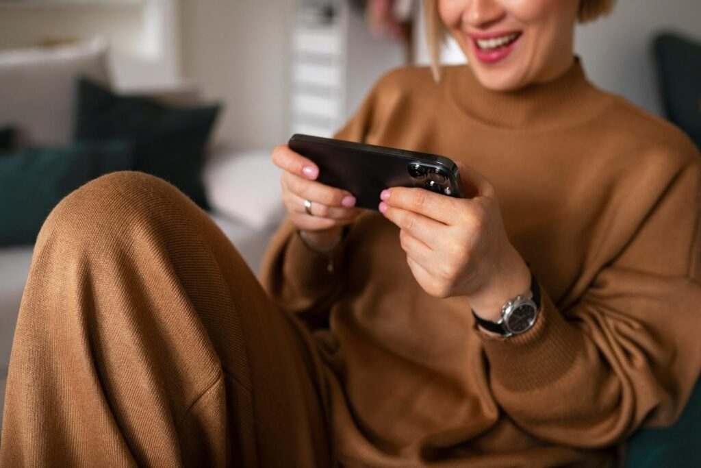 A female player interacts with a region-specific mobile game