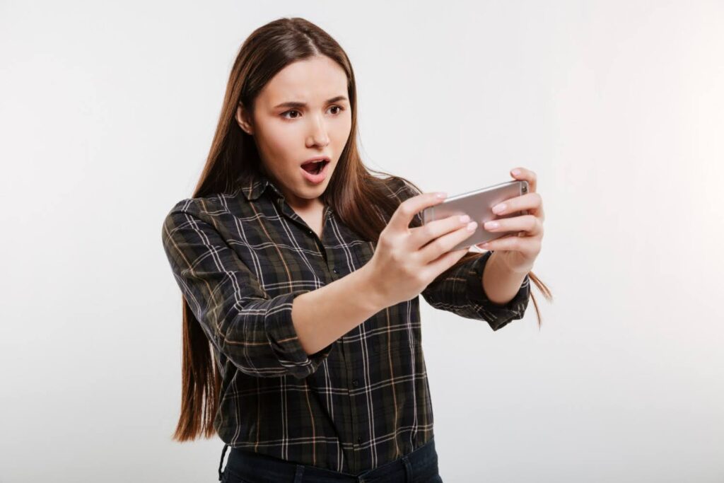 A female gamer gets immersed in a localized mobile game experience
