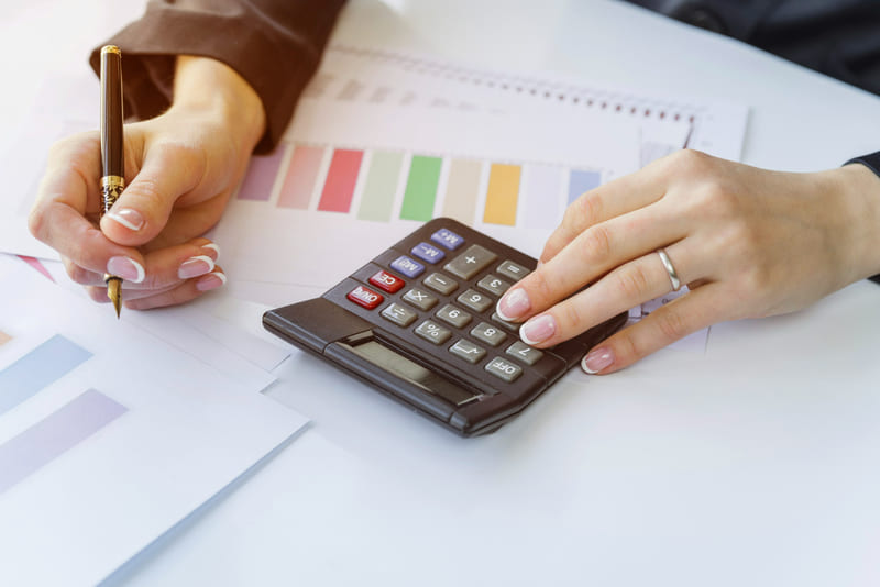 Financial evaluation using a calculator to measure post-launch localization costs.