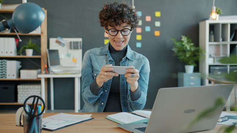 Casual gamer playing mobile game during spare time.