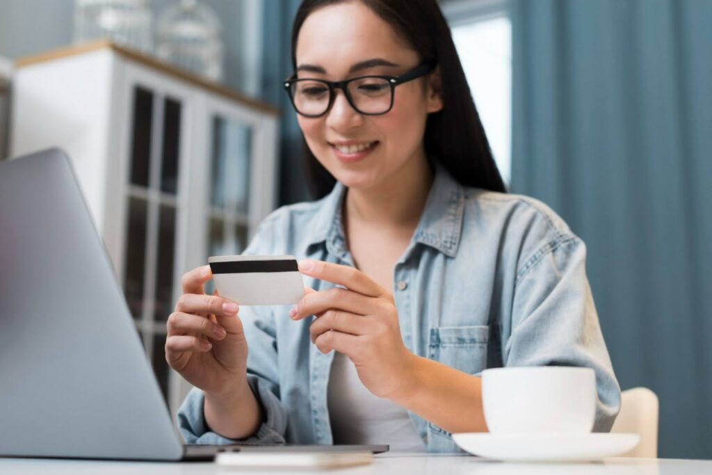 A female player uses her laptop to make microtransactions for game items.