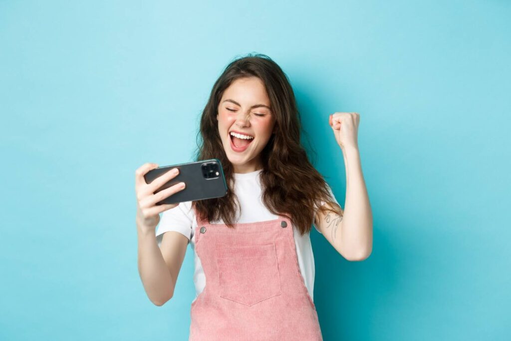 A gamer is immersed in an AI-powered game with an interactive design on her phone.