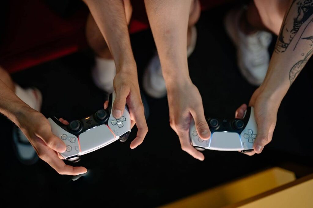 Two gamers holding controllers while enjoying a localized video game.