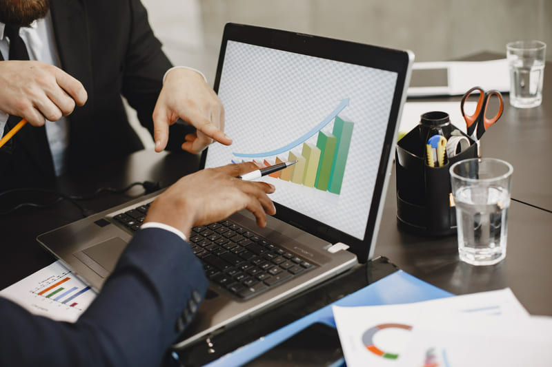 Game developers analyzing revenue growth chart to design in-game purchases for Indonesian players.