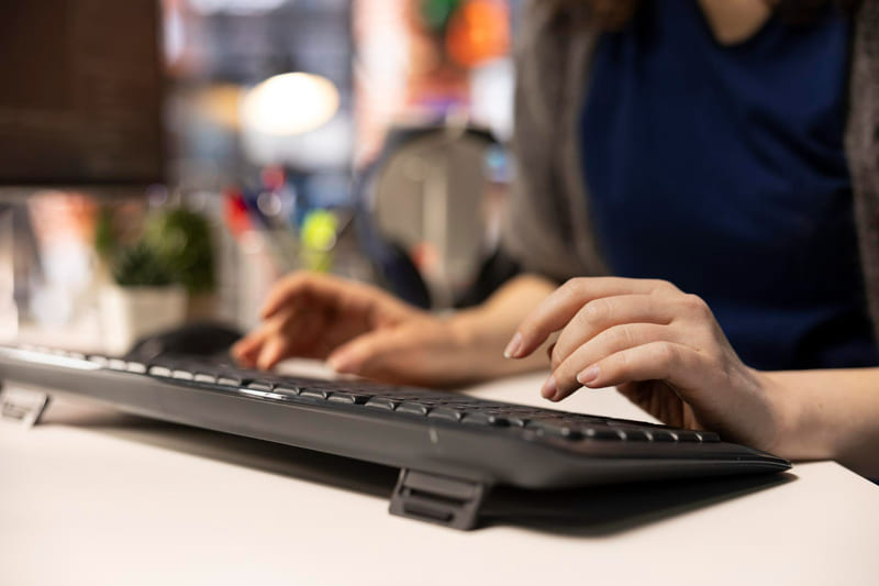 A developer uses a computer to perform a self-assessment for game rating compliance.