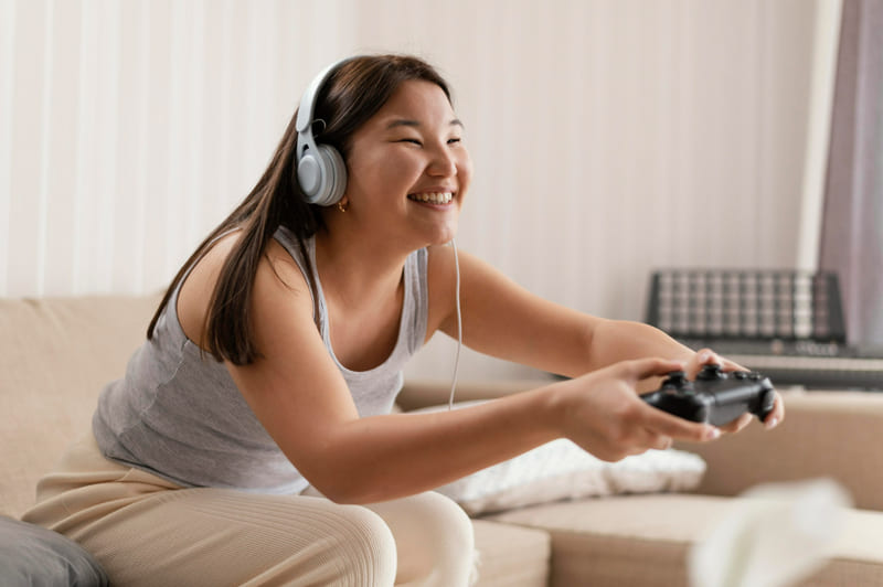 A female player gets immersed in a game world, which is enhanced with localized audio.