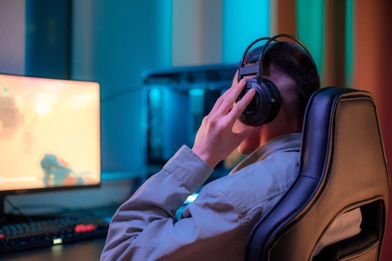 A gamer immersed in an enjoyable gameplay experience that maintains overall game balance
