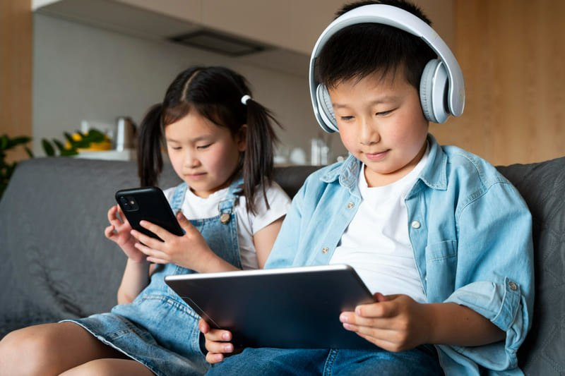 Two children enjoyed online games supported by rating systems that promote safer digital experiences