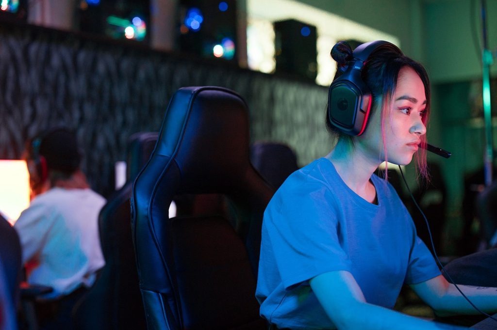 A close-up of a Thai female gamer deeply immersed in intensive PC Games.