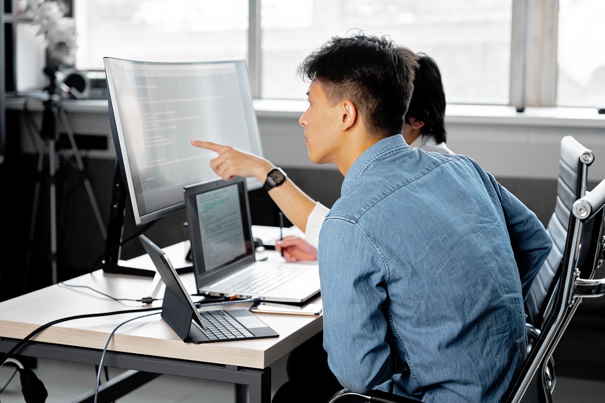 Two developers collaborate at a workstation, exploring how translation and localization shape the gaming experience.
