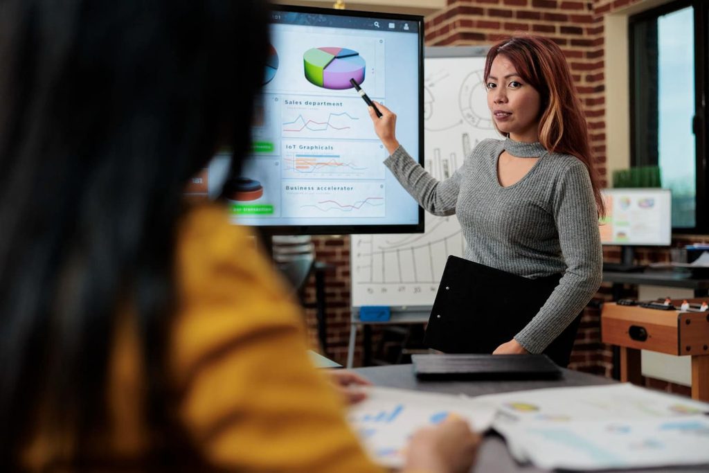 A developer team discusses marketing data and campaign plans for a coordinated esports tournament localization strategy.